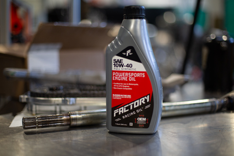 Quart or Factory Racing Parts Oil with tools in the backround